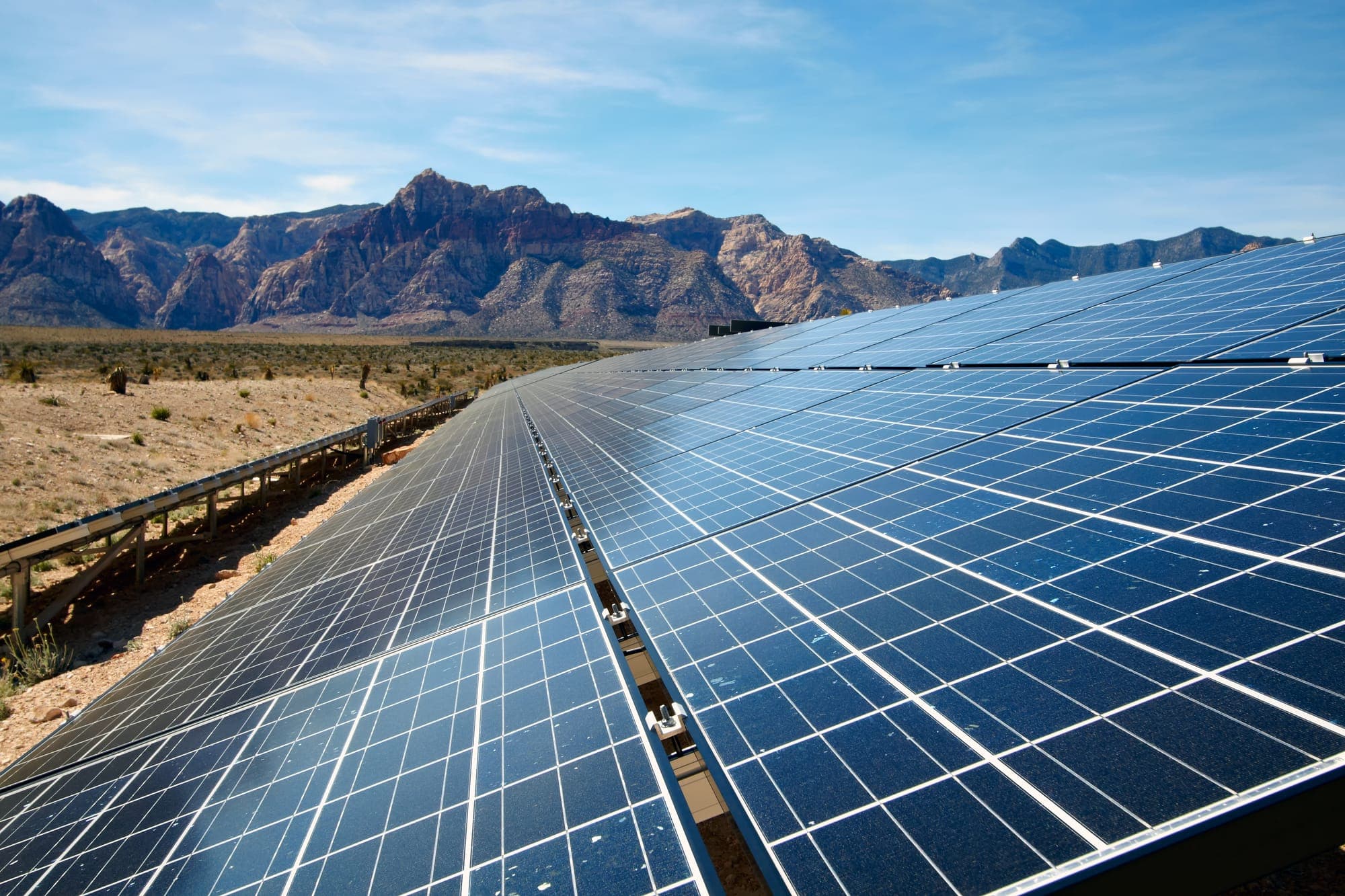 Solar array with red rock mountains behind